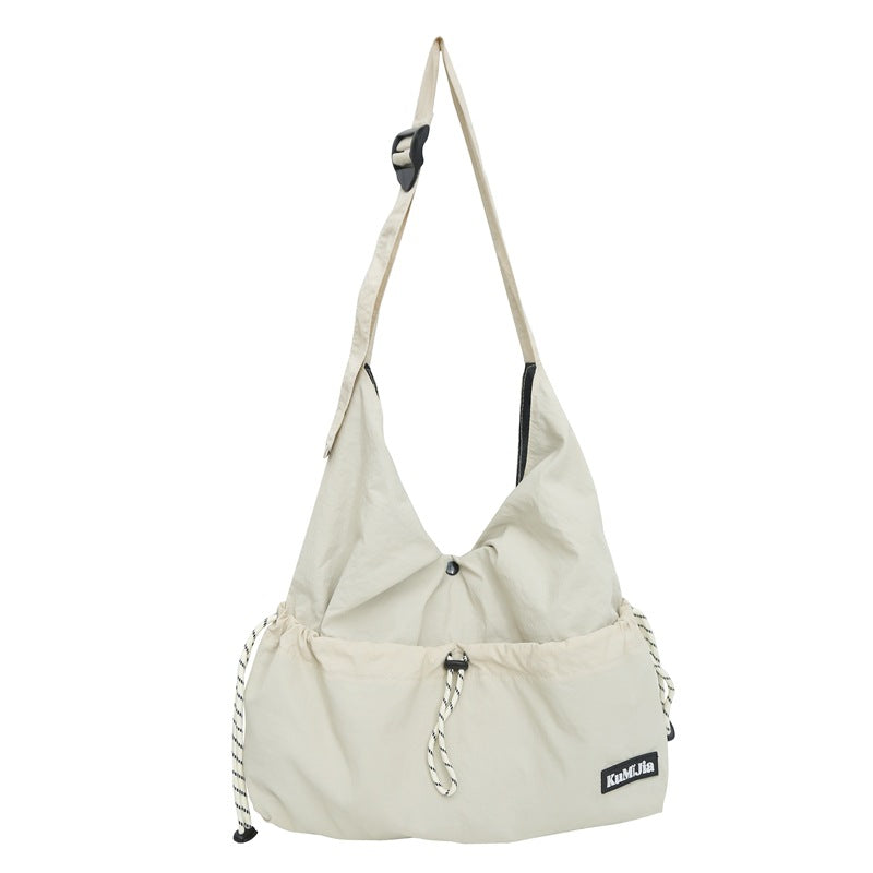 Z25030930日系輕便休閒斜背包女新款通勤單肩包抽繩工裝包